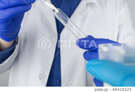 Medical laboratory assistant checks a test tube with sperm. Spermogram. Male fertility test. Semen in a test tube. Reproductive system check. Donor suitability test for artificial insemination Medical laboratory assistant checks a test tube with sperm. Spermogram. Male fertility test. Semen in a test tube. Reproductive system check. Donor suitability test for artificial insemination 89410325