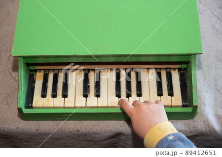 A boy playing a toy piano. A boy playing a toy piano. 89412651