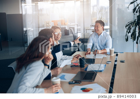Positive workteam of young asian businessman working together in an modern office 89414003