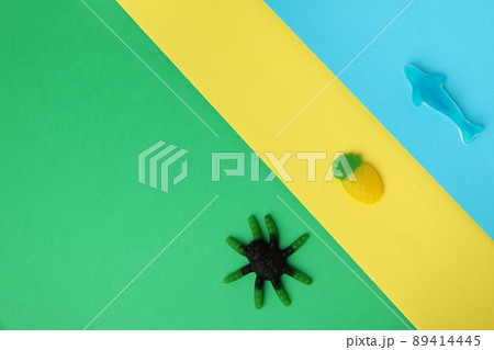 Tasty gummy candies on three tone background Tasty gummy candies on three tone background 89414445