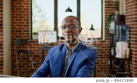 Portrait of businessman using laptop to browse internet in startup office, doing project research. Executive manager sending paperwork email, working on website browser application. Portrait of businessman using laptop to browse internet in startup office, doing project research. Executive manager sending paperwork email, working on website browser application. 89415890