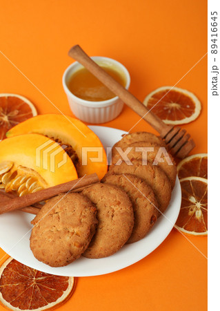 Concept of tasty food with pumpkin cookies on orange background Concept of tasty food with pumpkin cookies on orange background 89416645