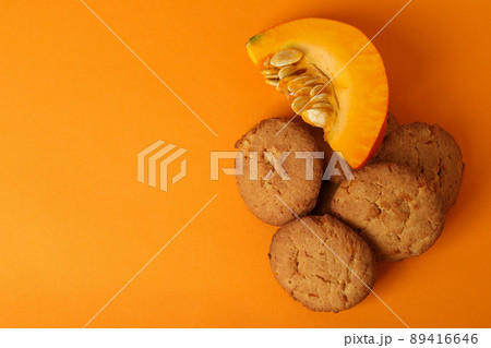 Pumpkin cookies on orange background, space or text Pumpkin cookies on orange background, space or text 89416646