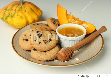 Concept of tasty food with pumpkin cookies on white background 89416687
