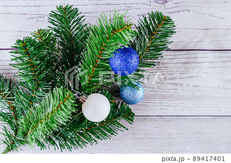 Christmas or New Year background: fur-tree, branches, colored glass balls and toys, gifts, decoration on a white Christmas or New Year background: fur-tree, branches, colored glass balls and toys, gifts, decoration on a white 89417401