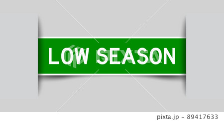 Inserted green color label sticker with word low season on gray background Inserted green color label sticker with word low season on gray background 89417633
