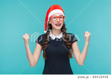 VIctory concept. Happiness woman rejoicing her win. Studio shot, blue background 89418448