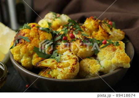 Concept of tasty food with baked cauliflower, close up Concept of tasty food with baked cauliflower, close up 89418674