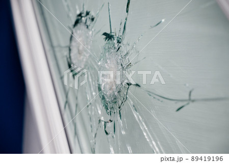 The mark of a shot from a bullet on the glass The mark of a shot from a bullet on the glass 89419196