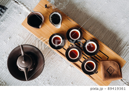 Preparing for a tea ceremony with a large company Preparing for a tea ceremony with a large company 89419361
