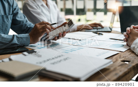 Accountant or bookkeeper working with calculator to calculate business data summary report, accountancy document and laptop computer at office, business meeting concept Accountant or bookkeeper working with calculator to calculate business data summary report, accountancy document and laptop computer at office, business meeting concept 89420901