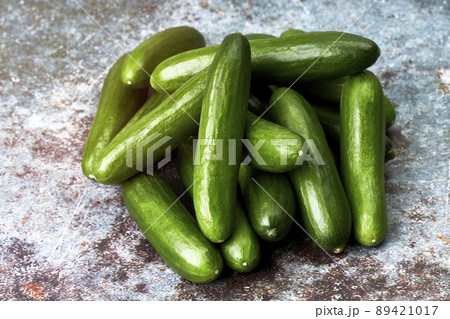 Pile of healthy and ecological baby cucumbers. Vegan and vegetarian food 89421017