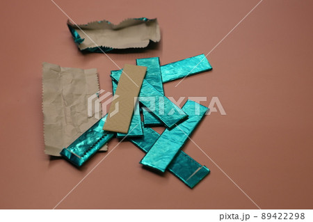 Mint sticks of gum are strewn across the table. Sweet chewing gum for cleaning the mouth from food. 89422298