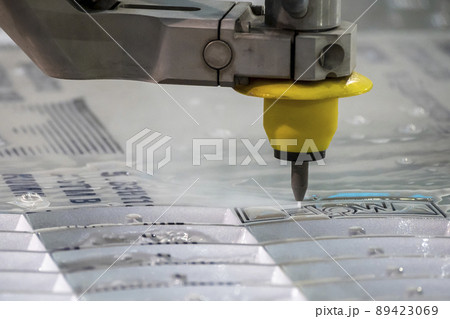 Close-up scene of multi-axis waterjet cutting machine cutting the aluminum plate. 89423069