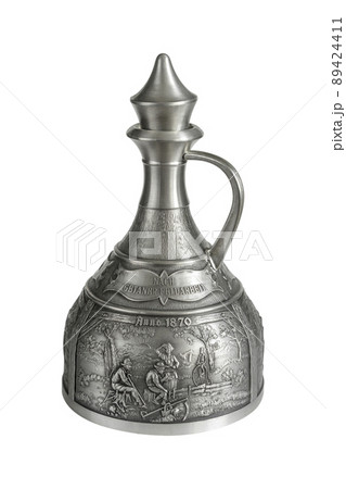 Vintage pewter decanter isolated on a white background. Vintage pewter decanter isolated on a white background. 89424411