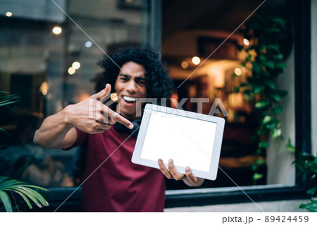 Blurred male blogger showing gadget notification for app Blurred male blogger showing gadget notification for app 89424459