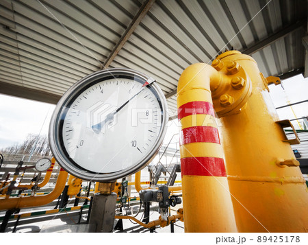 Yellow gas pipeline with a large pressure gauge for measuring gas pressure Yellow gas pipeline with a large pressure gauge for measuring gas pressure 89425178