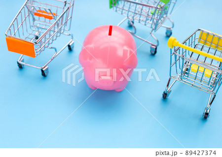 Pink piggy bank with shopping cart Pink piggy bank with shopping cart 89427374
