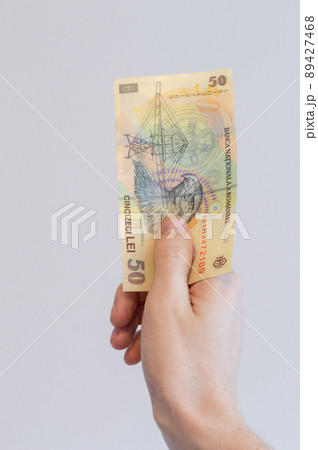 50 Romanian lei banknote in hand. 89427468