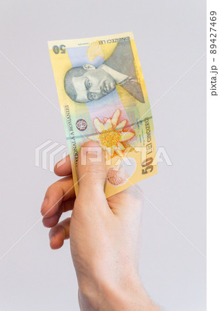 50 Romanian lei banknote in hand. Banknote with portrait of Aurel Vlaicu, pilot and airplane builder. 89427469