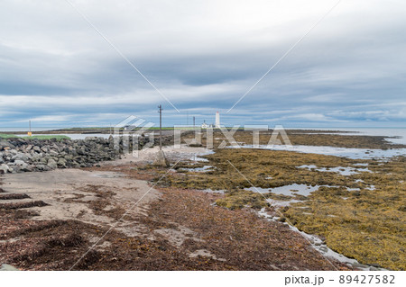 Landscape view with Grotta Island Lighthouse at cloudy day. Landscape view with Grotta Island Lighthouse at cloudy day. 89427582