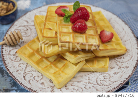 sweet dessert Belgian waffles with strawberries on a plate sweet dessert Belgian waffles with strawberries on a plate 89427716