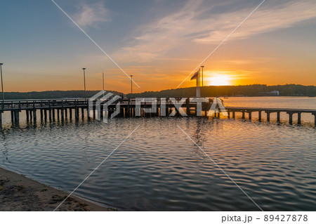 Wooden pier at sunset time on Ukiel lake. Wooden pier at sunset time on Ukiel lake. 89427878