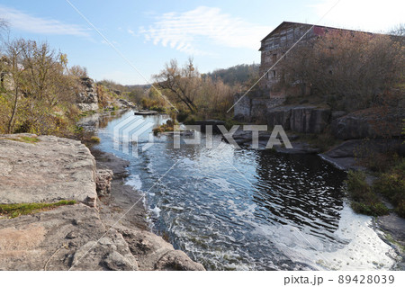 Rocky bank, mountain landscape. View of mountain river in early spring. Nature landscape, wilderness. Tikich river Rocky bank, mountain landscape. View of mountain river in early spring. Nature landscape, wilderness. Tikich river 89428039