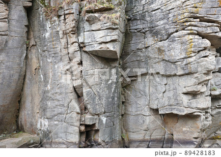 Light coarse natural rock stone background. Mining cliff rough front surface. Big limestone stack backdrop. Heavy grunge damaged granite block texture Light coarse natural rock stone background. Mining cliff rough front surface. Big limestone stack backdrop. Heavy grunge damaged granite block texture 89428183