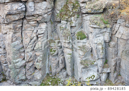 Light coarse natural rock stone background. Mining cliff rough front surface. Big limestone stack backdrop. Heavy grunge damaged granite block texture Light coarse natural rock stone background. Mining cliff rough front surface. Big limestone stack backdrop. Heavy grunge damaged granite block texture 89428185