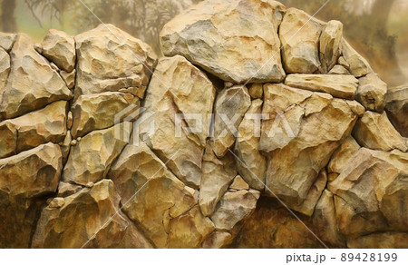 Light coarse natural rock stone background. Mining cliff rough front surface. Big limestone stack backdrop. Heavy grunge damaged granite block texture Light coarse natural rock stone background. Mining cliff rough front surface. Big limestone stack backdrop. Heavy grunge damaged granite block texture 89428199