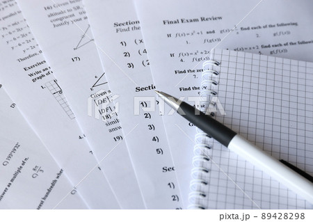 Handwriting of mathematics quadratic equation on examination, practice, quiz or test in maths class. Solving exponential equations concept. 89428298