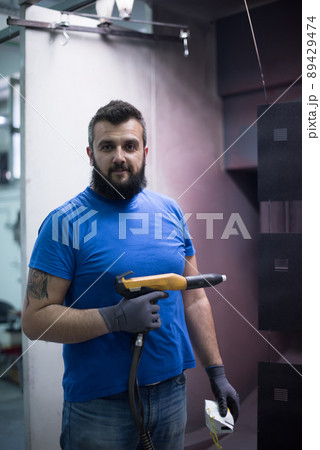 The painter paints the iron element. Industrial painting parts. Metal designs The painter paints the iron element. Industrial painting parts. Metal designs 89429474
