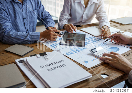 Three business people meeting at wooden desk, analysis and calculate accounting finance data, stats. Three business people meeting at wooden desk, analysis and calculate accounting finance data, stats. 89431297