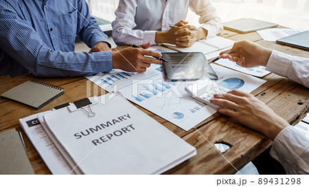 Team work discussing in valuation data in meeting room, three business people with accounting paper charts. Team work discussing in valuation data in meeting room, three business people with accounting paper charts. 89431298