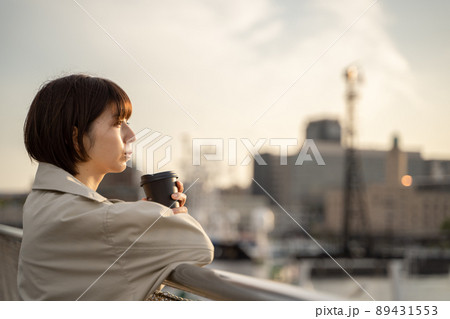 屋外でコーヒーを飲みながら物思いにふける女性の様子 屋外でコーヒーを飲みながら物思いにふける女性の様子 89431553