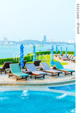 chair pool and umbrella around swimming pool 89431918