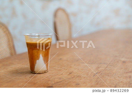 Specialty coffee menu called 'Dirty coffee' . Cold milk in the bottom with hot espresso shot on top 89432269