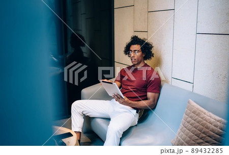 Young male blogger typing text publication via application on digital tablet 89432285