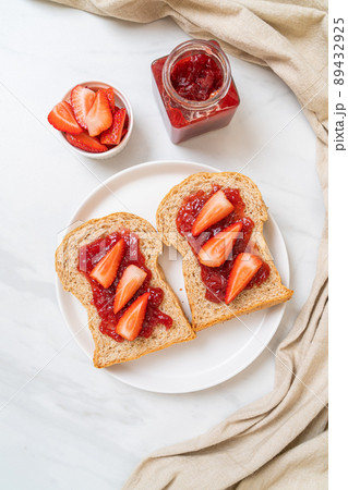 whole wheat bread with strawberry jam and fresh strawberry 89432925