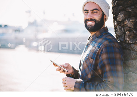 Happy Middle Eastern male blogger with cellular Happy Middle Eastern male blogger with cellular 89436470
