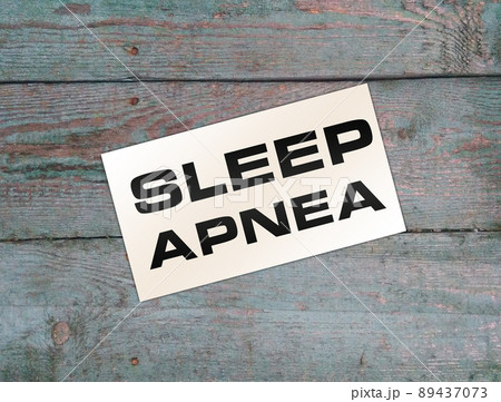 Text Sleep APNEA on card on wooden table. Healthcare concept 89437073