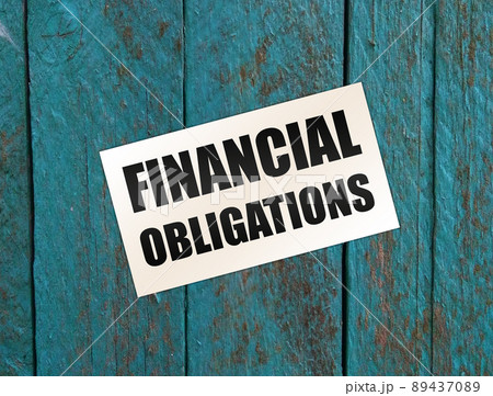 Financial Obligation words on card on wooden table. Business debts concept 89437089