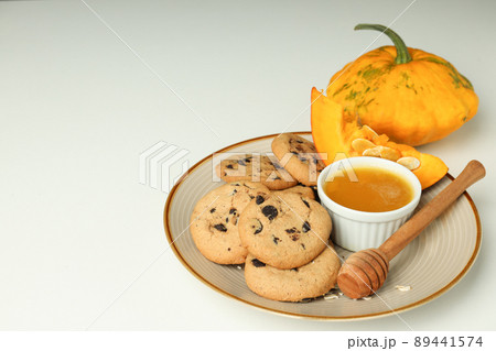 Concept of tasty food with pumpkin cookies on white background 89441574