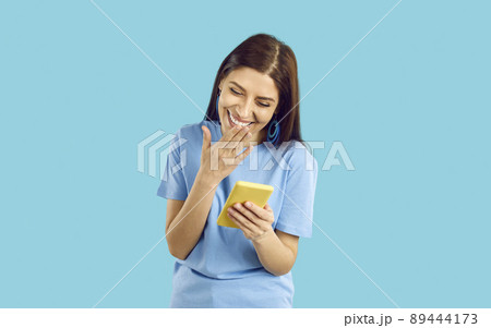 Funny girl laugh at text message on phone Funny girl laugh at text message on phone 89444173