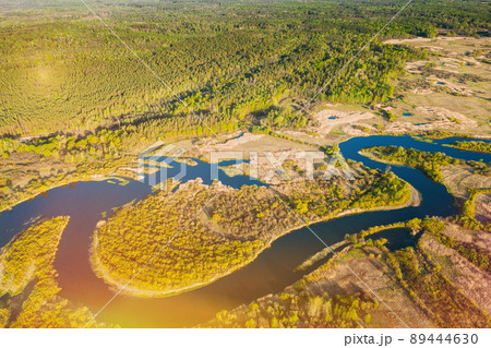 Aerial View Green Forest Woods And River Landscape In Sunny Summer Day. Top View Of Beautiful European Nature From High Attitude In Season. Drone View. Bird's Eye View Aerial View Green Forest Woods And River Landscape In Sunny Summer Day. Top View Of Beautiful European Nature From High Attitude In Season. Drone View. Bird's Eye View 89444630