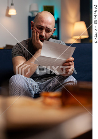 Sad disappointed man feeling worried about eviction notice warning, needing to pay mortgage taxes. Desperate anxious adult with despression worrying about financial difficulties. Sad disappointed man feeling worried about eviction notice warning, needing to pay mortgage taxes. Desperate anxious adult with despression worrying about financial difficulties. 89444692