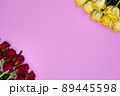 Cute Pink background with diagonal corners from red roses and yellow roses. With large copy space ready for design, banners, blanks and posters. 89445598