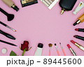 Women's makeup and cosmetic accessories on a pink background, copy space and red rose, top view concept. 89445600