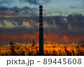 Smoking industrial chimney at beautiful sunset. Beautiful industrial golden hour. 89445608